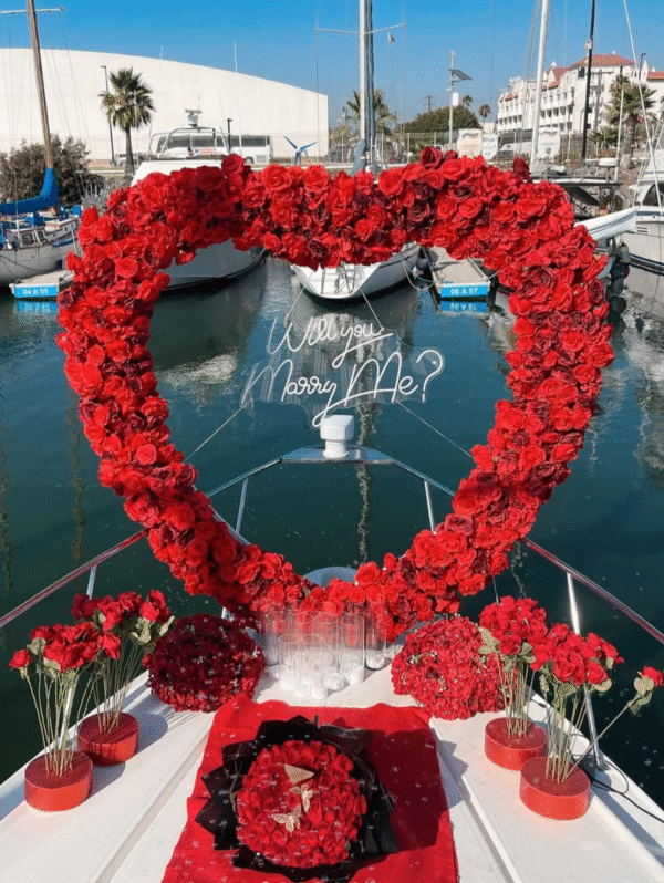 Proposal arch of roses with question's neon